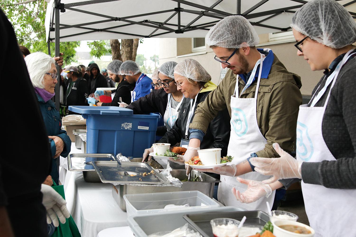Bissell Centre staff serving meals to the community