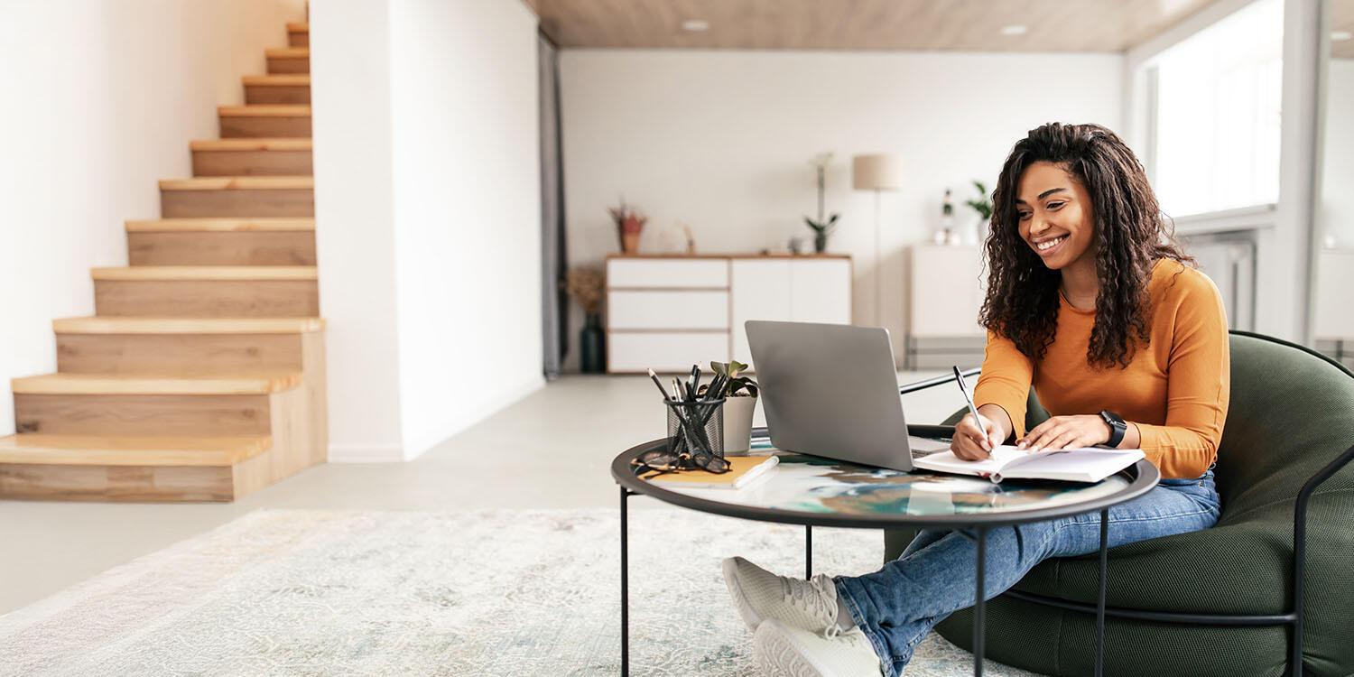 Internships Young woman working on laptop with notebook